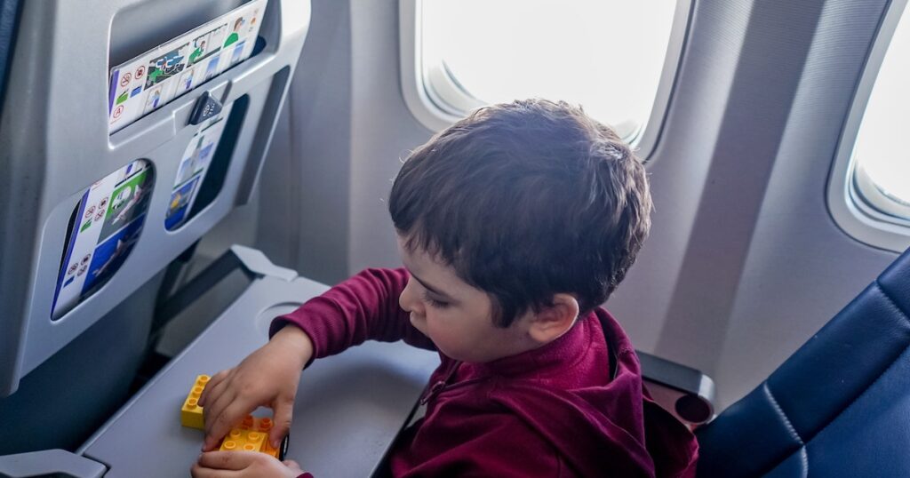 child sitting on airplane